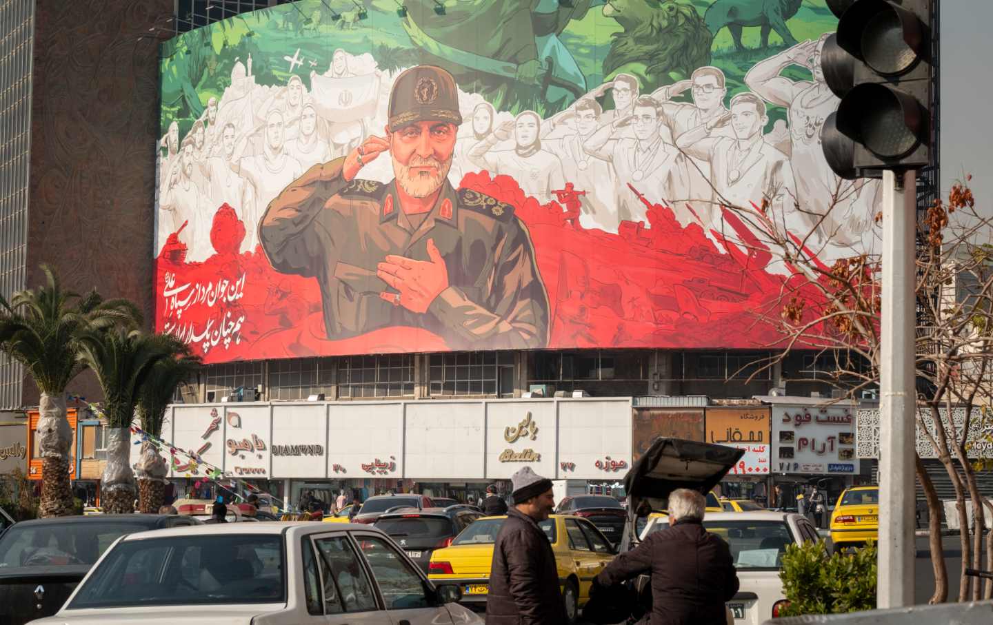 A billboard depicting symbolic images of former commander of the Islamic Revolutionary Guard Corps Quds Force Maj. Gen. Qassem Soleimani and Iranian athletes is hung on a state building in downtown Tehran, Iran, on January 6, 2026.