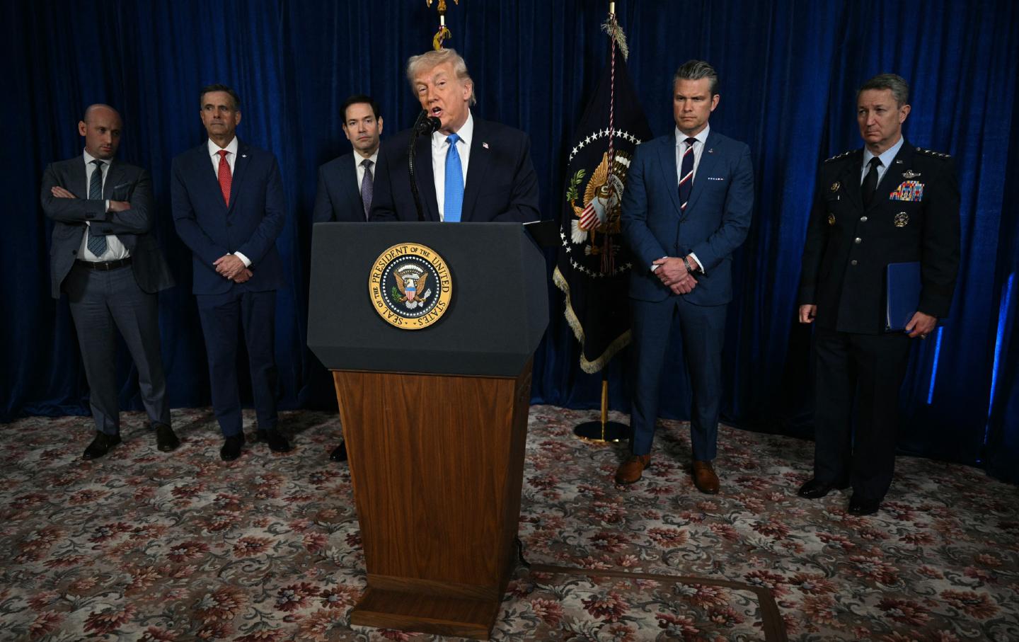President Donald Trump, alongside deputy chief of staff Stephen Miller, CIA Director John Ratcliffe, Secretary of State Marco Rubio, Secretary of Defense Pete Hegseth, and Chairman of the Joint Chiefs of Staff Gen. Dan Caine, speaks to the press following US military actions in Venezuela, at his Mar-a-Lago residence in Palm Beach, Florida, on January 3, 2026.
